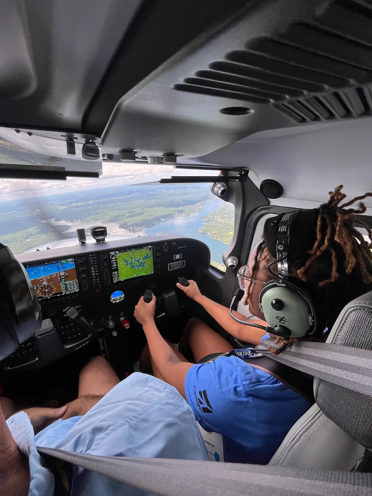 An ACE camper takes the controls on a discovery flight over the lake
