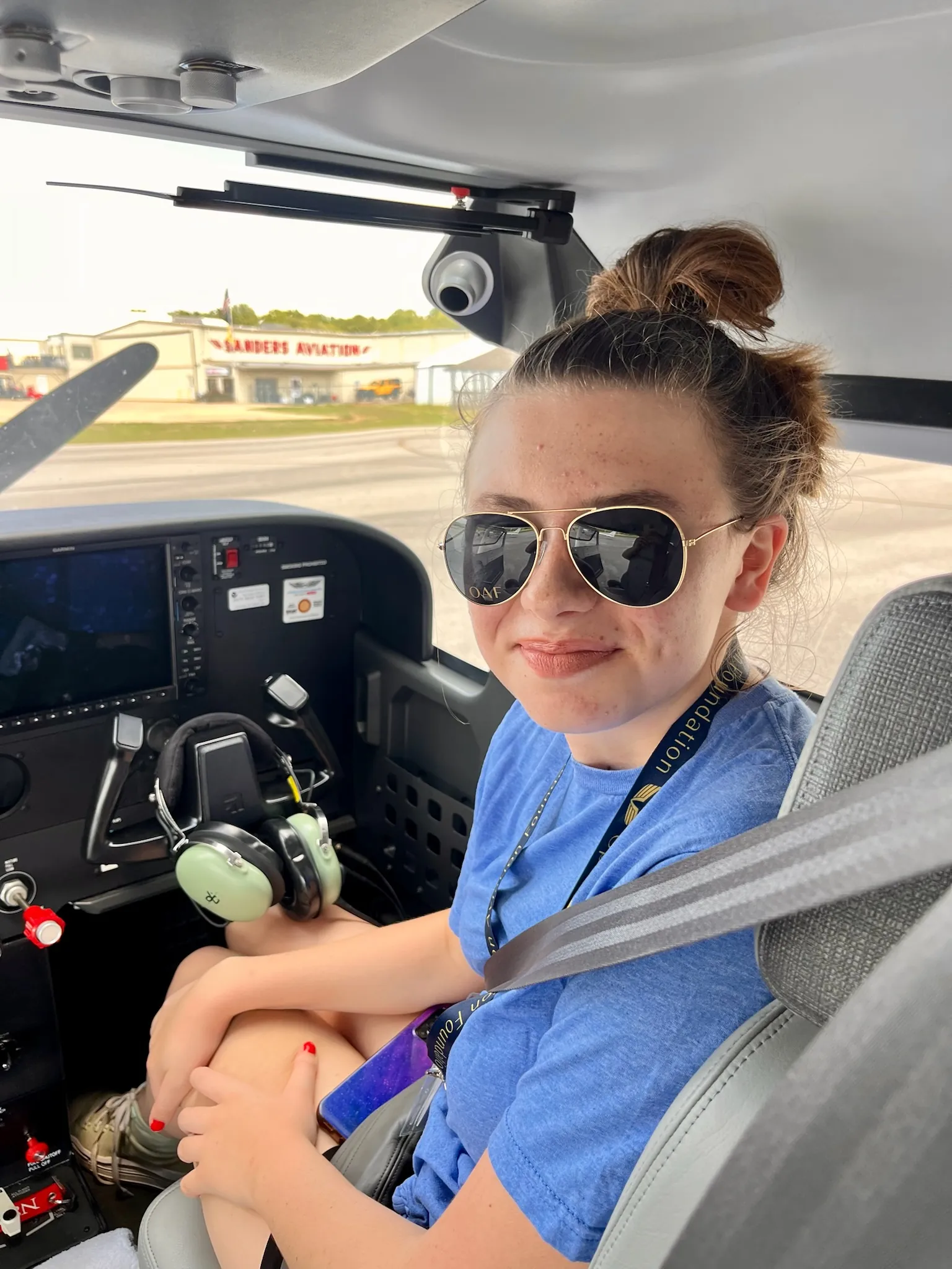 A camper in aviator shades takes the controls in the cockpit