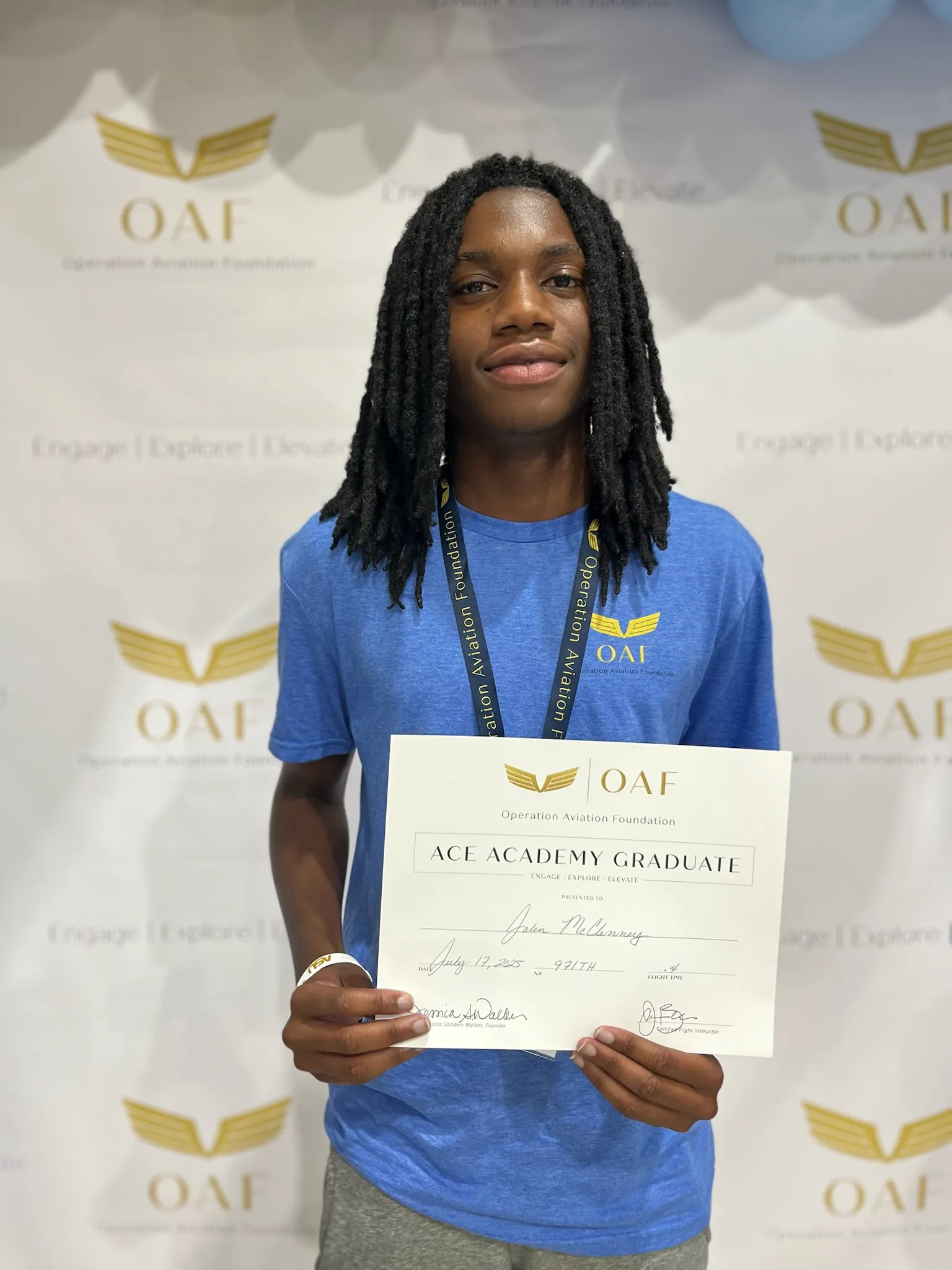 A camper proudly holds his ACE Academy graduate certificate
