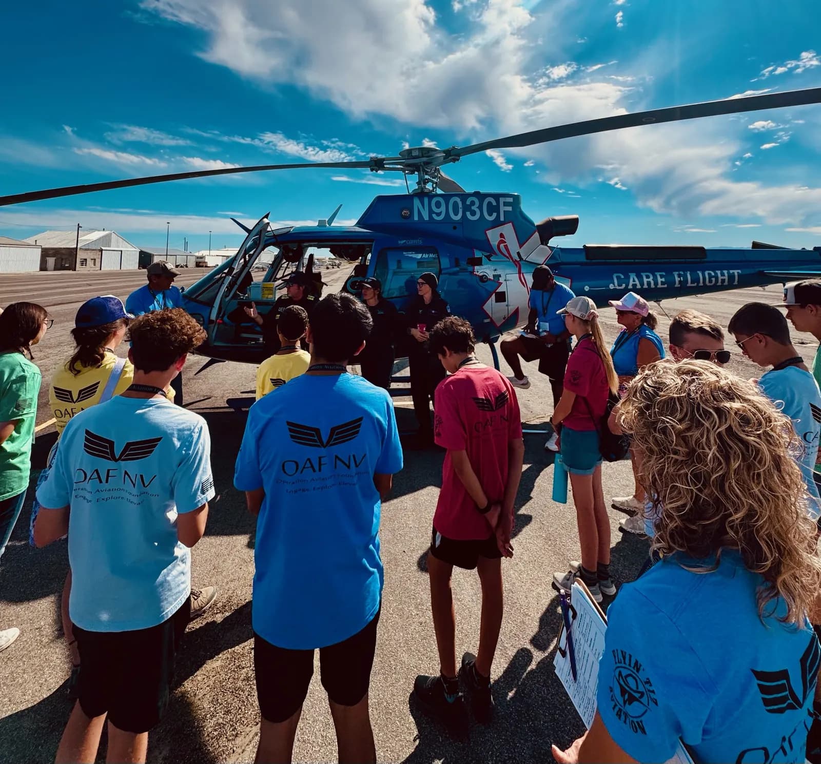 Students explore a helicopter at a community event