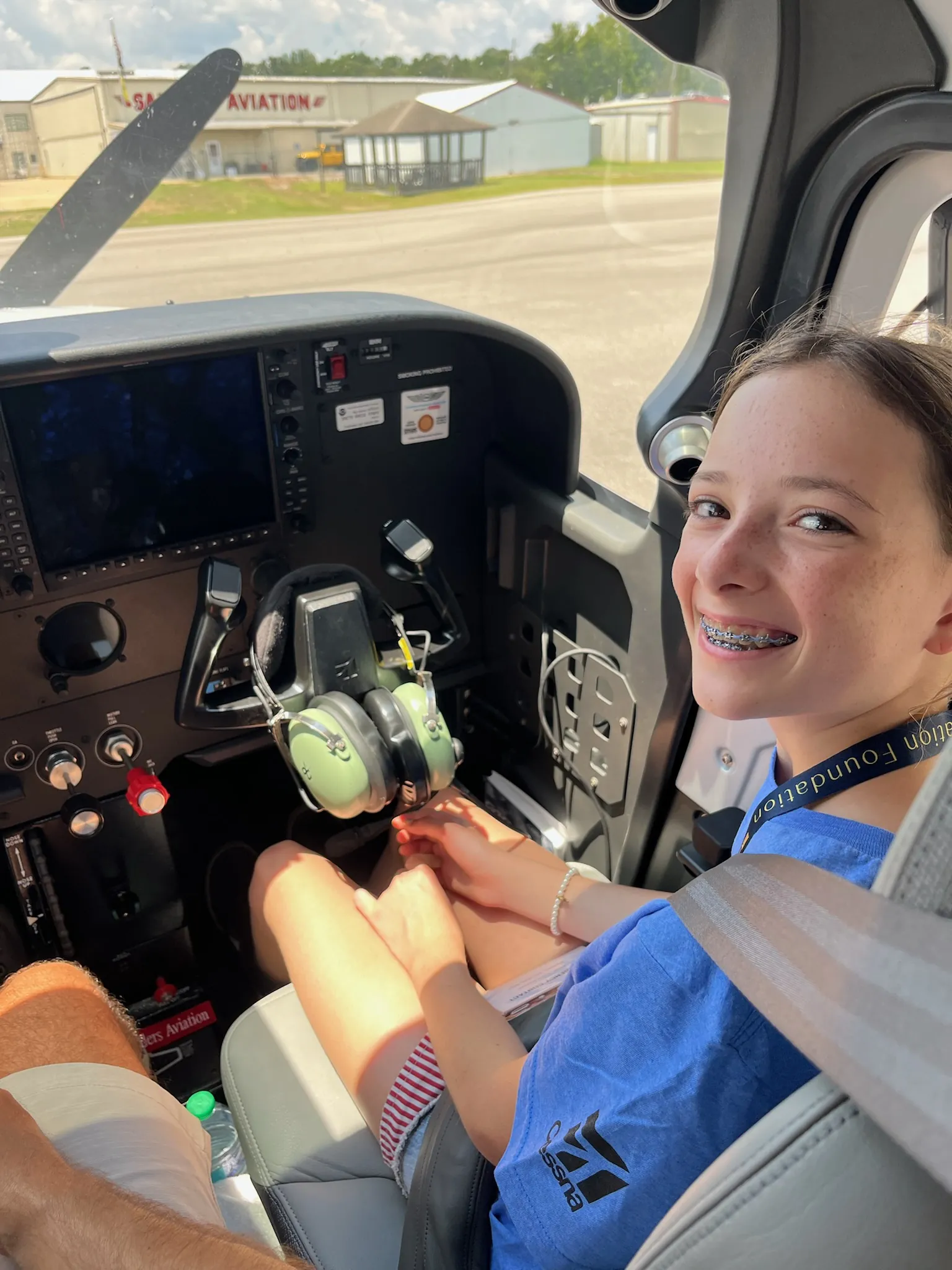 An ACE camper smiles from the cockpit on a discovery flight